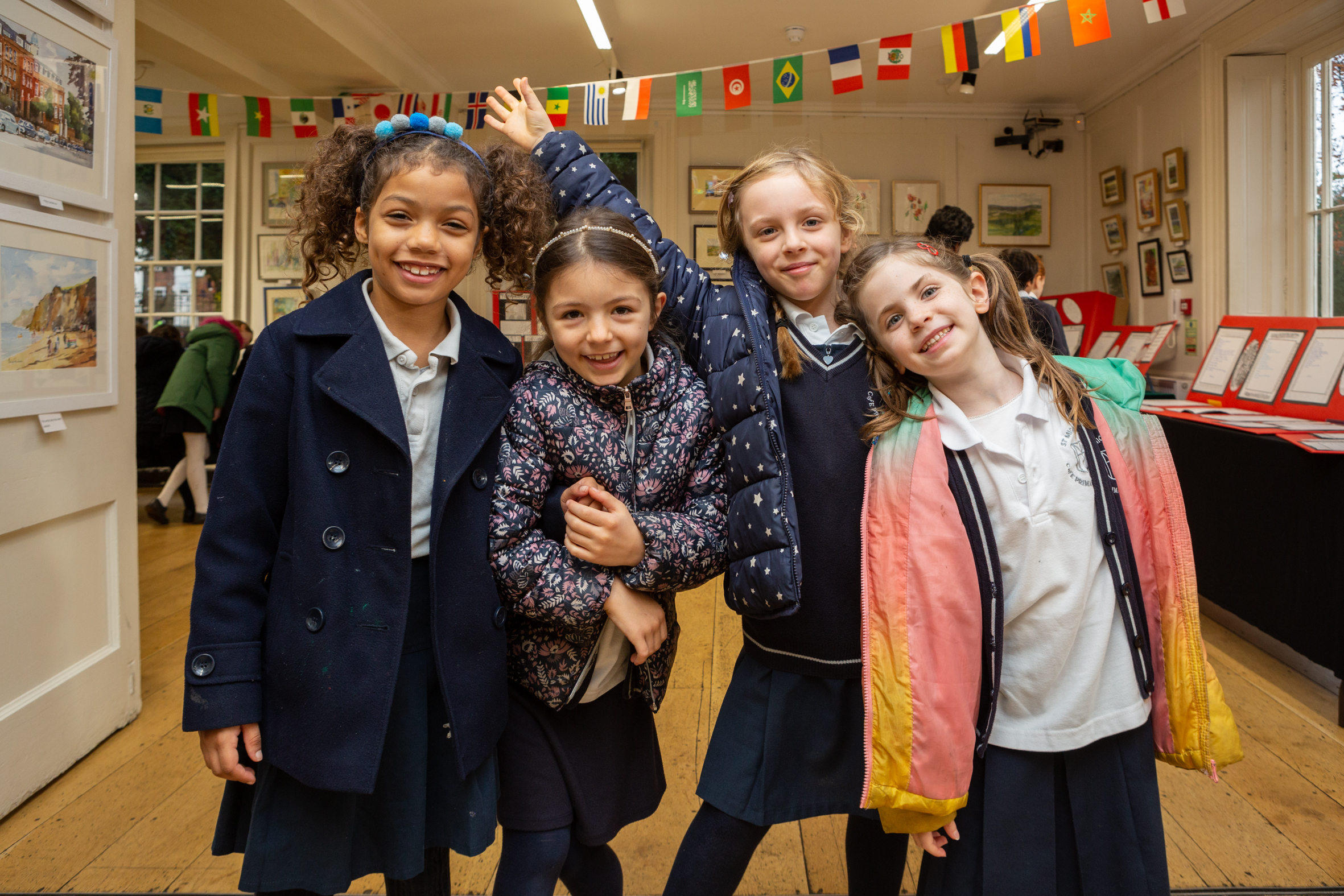 Four schoolgirls posing for a photograph in a gallery at Lauderdale House during Takeover Day.