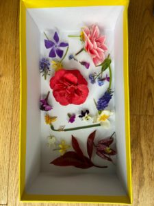 A yellow box containing a collection of spring flowers.