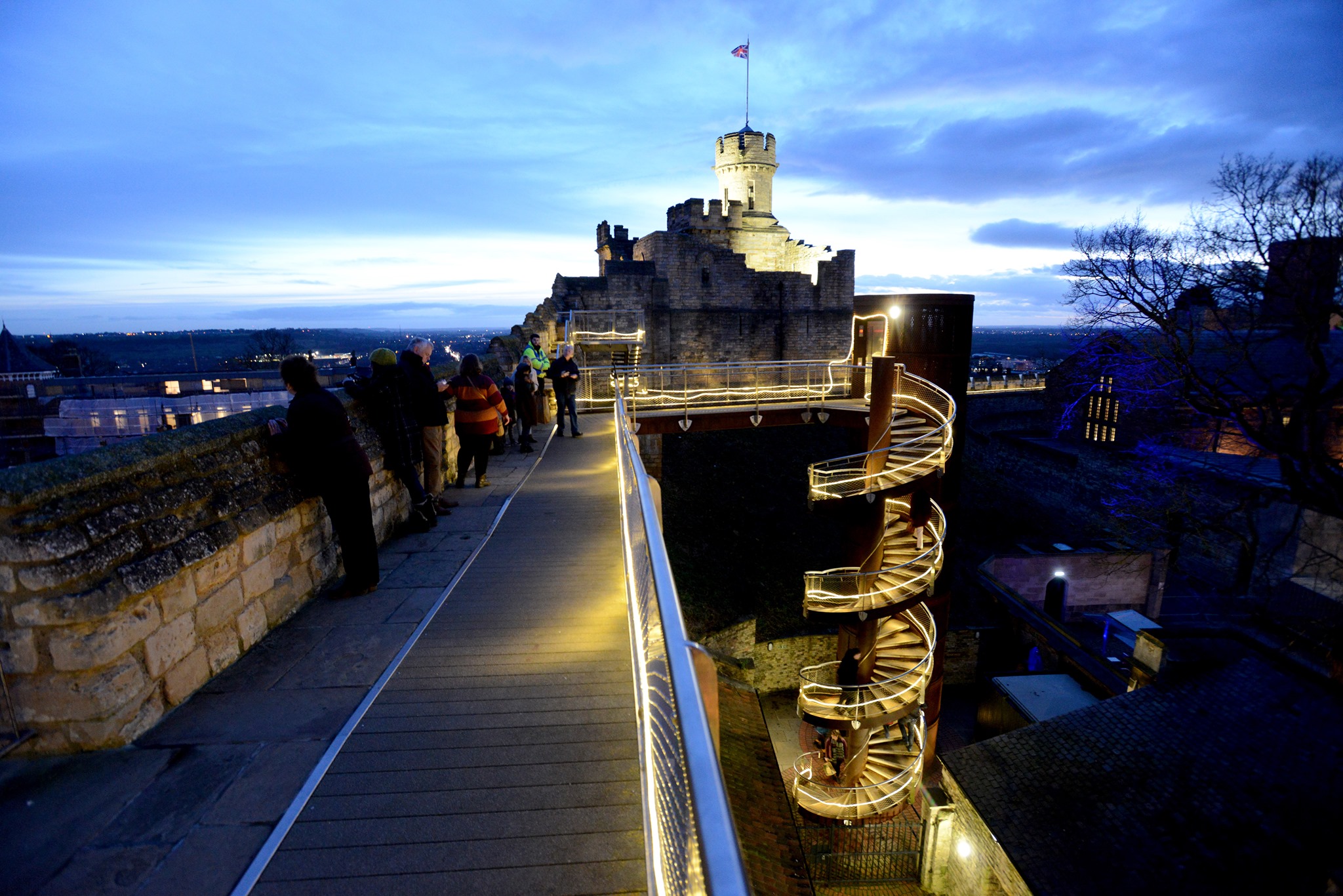 The walls of Lincoln Castle lit up by lights.