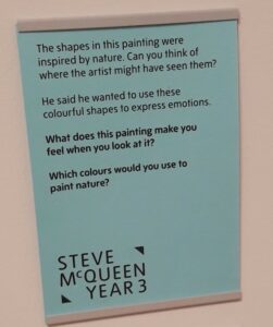 A small panel from Tate reading: 'The shapes in this painting were inspired by nature. Can you think of where the artist might have seen them? He said he wanted to use these colourful shapes to express emotions. What does this painting make you feel when you look at it? Which colours would you use to paint nature?' A logo in the bottom read Steve McQueen Year 3.